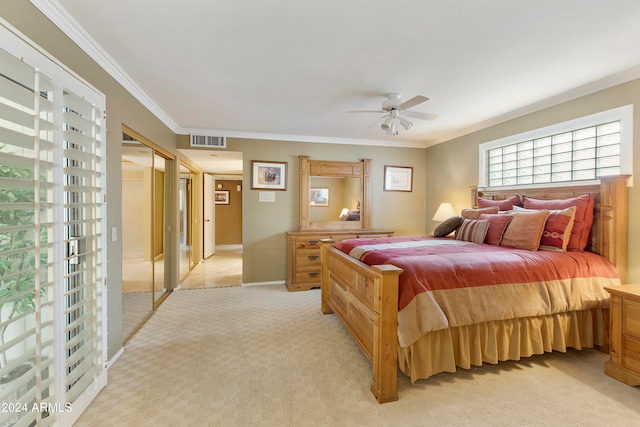 bedroom featuring a closet, light colored carpet, ceiling fan, and ornamental molding