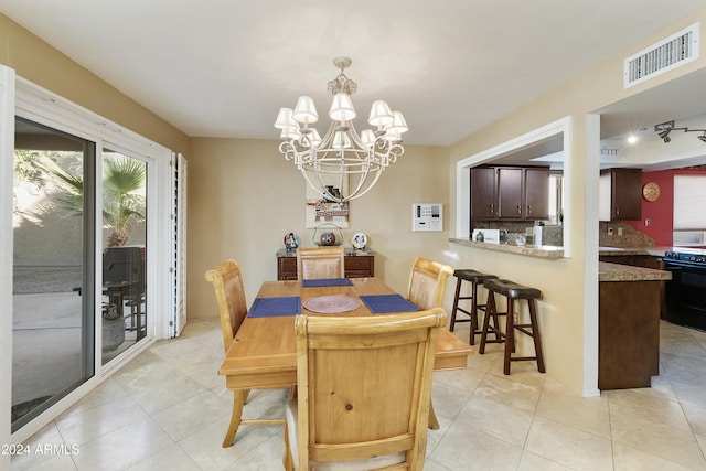 dining space featuring light tile patterned floors and a chandelier