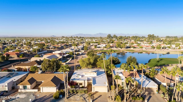 birds eye view of property with a water and mountain view