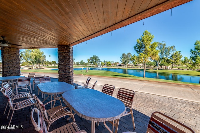 view of patio / terrace featuring a water view and ceiling fan