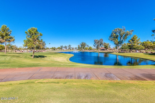 surrounding community with a yard and a water view