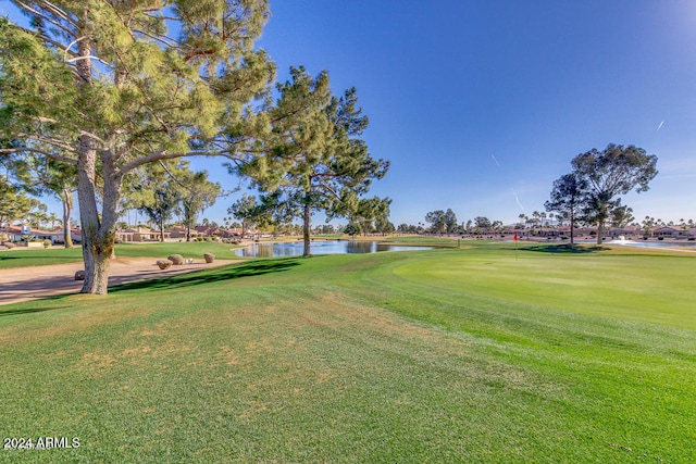 view of property's community featuring a yard and a water view