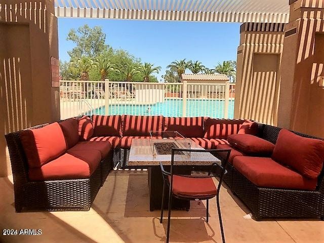 view of patio / terrace with a fenced in pool and an outdoor living space