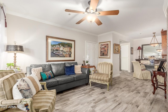 living room with ceiling fan, ornamental molding, and light hardwood / wood-style floors