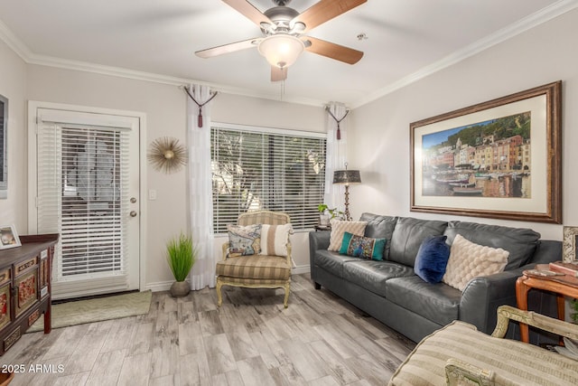 living room with crown molding, ceiling fan, and light wood-type flooring