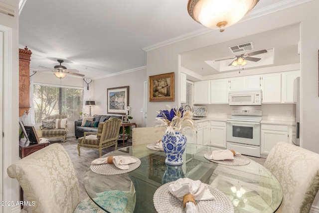 dining room with ceiling fan, ornamental molding, and sink