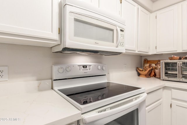 kitchen featuring white appliances and white cabinets