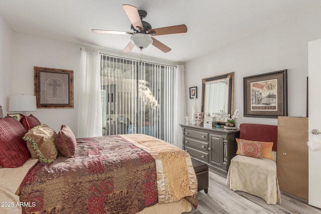 bedroom featuring access to exterior, ceiling fan, and light hardwood / wood-style flooring