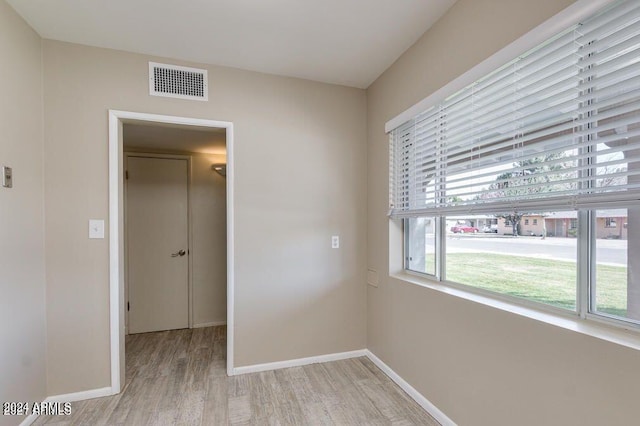 empty room with light hardwood / wood-style floors