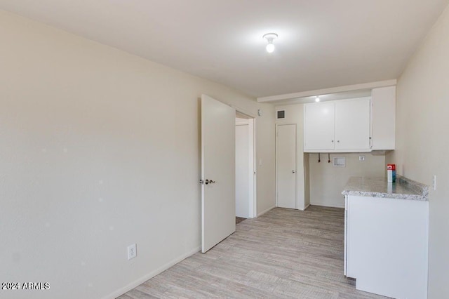 kitchen with white cabinets and light hardwood / wood-style floors