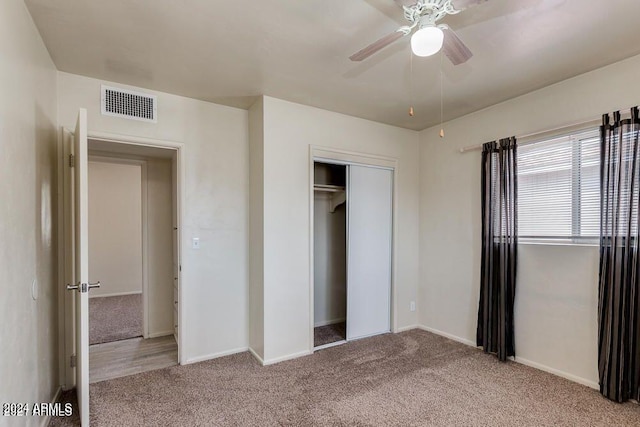 unfurnished bedroom featuring ceiling fan, a closet, and carpet