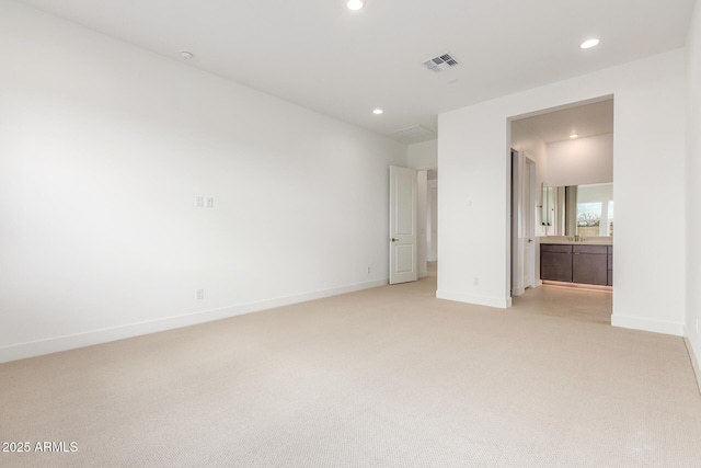 unfurnished bedroom featuring light carpet, baseboards, visible vents, and recessed lighting