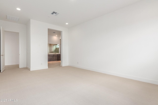 unfurnished bedroom with light carpet, baseboards, visible vents, and recessed lighting