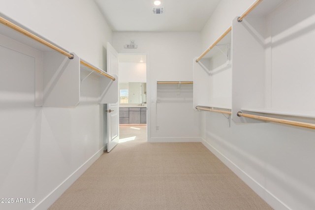 spacious closet with light carpet and visible vents