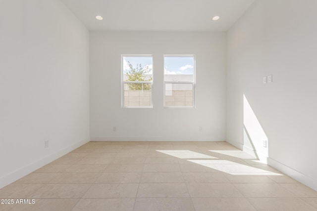 empty room with baseboards, light tile patterned flooring, and recessed lighting