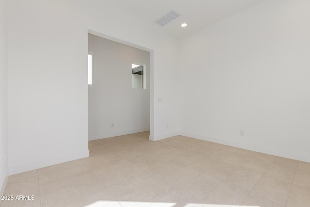 empty room with recessed lighting, visible vents, and baseboards