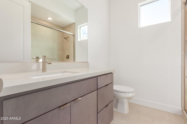 bathroom featuring toilet, a shower stall, baseboards, and vanity