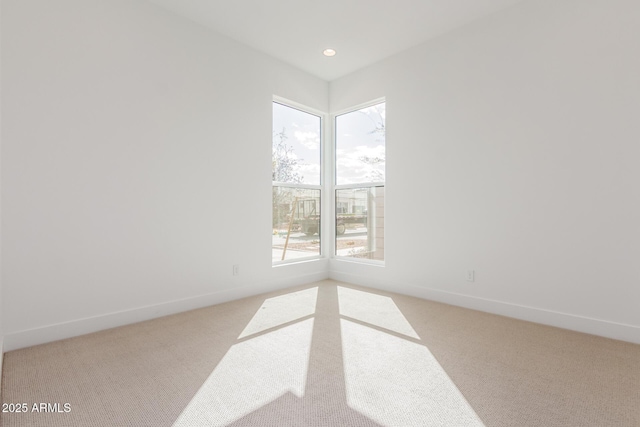 carpeted spare room with recessed lighting, plenty of natural light, and baseboards