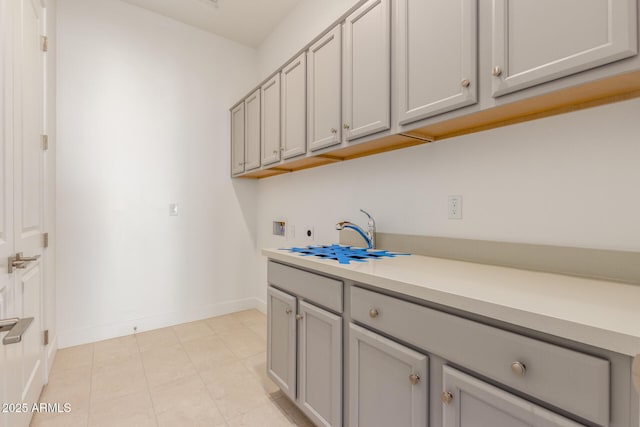 laundry area featuring washer hookup, cabinet space, electric dryer hookup, and baseboards