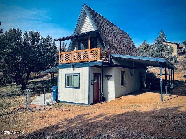 rear view of property with a balcony