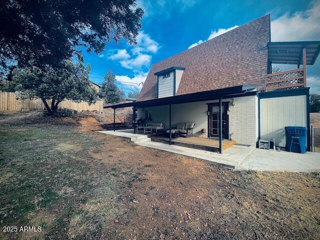 rear view of house with a yard and a patio area