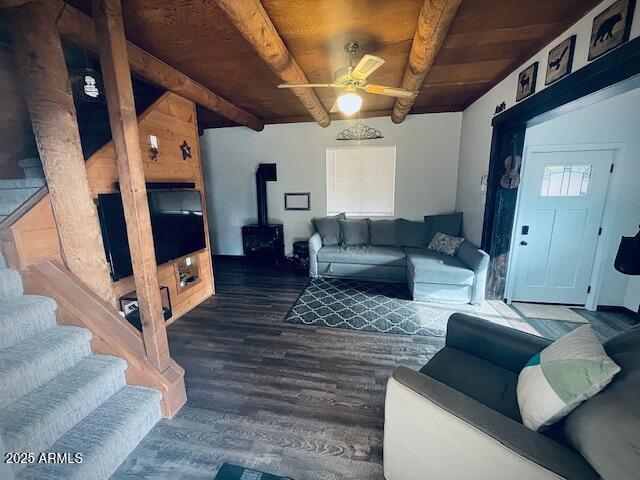 living room featuring beamed ceiling, dark hardwood / wood-style floors, ceiling fan, and wooden ceiling