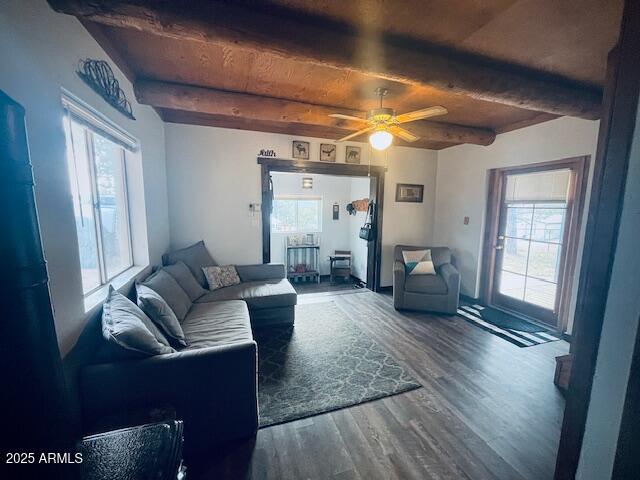 living room with beamed ceiling, wood-type flooring, and ceiling fan