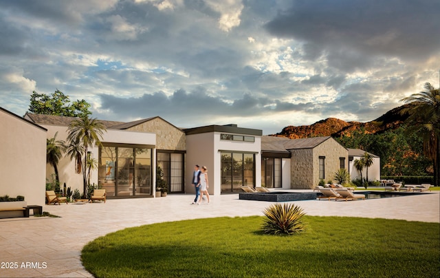 5636 E Caballo Dr, Paradise Valley, AZ 85253 - back of property featuring a lawn, a mountain view, and stucco siding