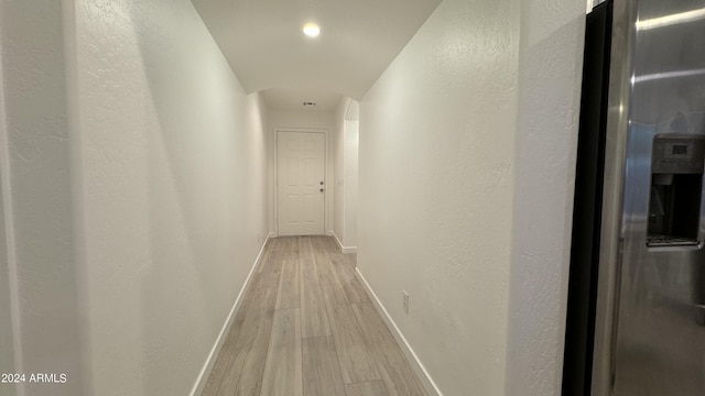 hallway with baseboards and light wood-style floors