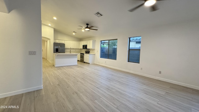 unfurnished living room with light wood-style flooring, visible vents, a ceiling fan, vaulted ceiling, and baseboards