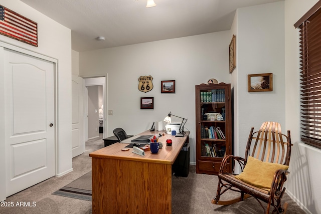 carpeted office space featuring baseboards