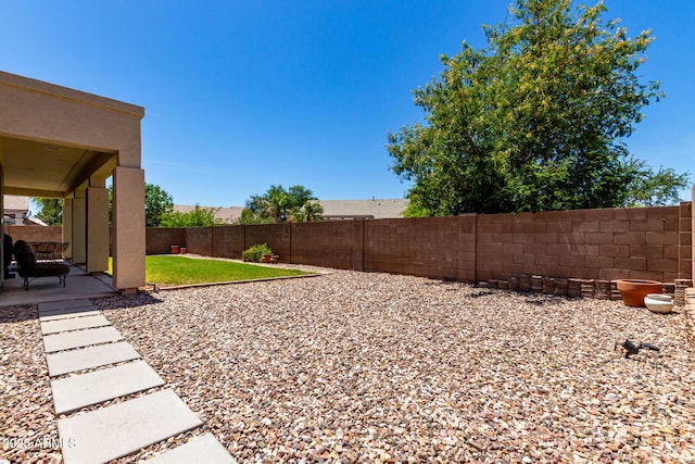 view of yard with a fenced backyard and a patio area
