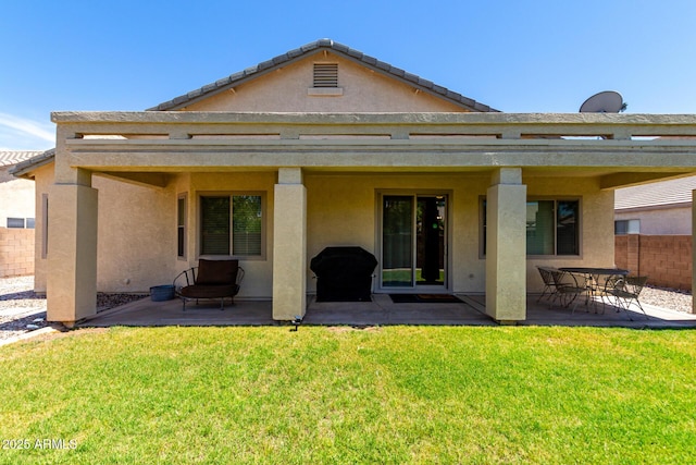 back of house with fence, stucco siding, and a patio area