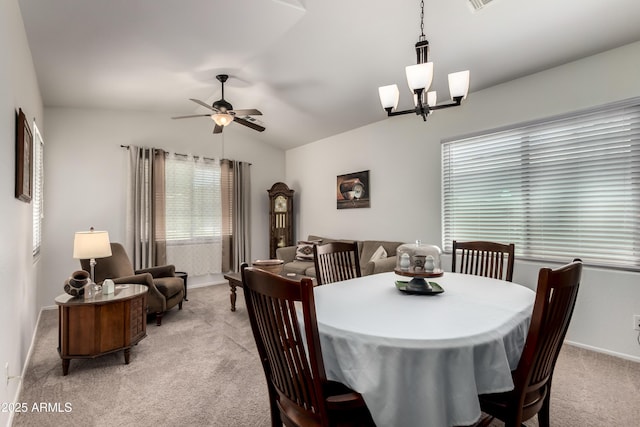 dining space featuring baseboards, a ceiling fan, vaulted ceiling, and light colored carpet