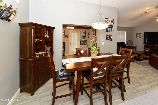 7916 E Naranja Ave, Mesa, AZ 85209 - dining room featuring vaulted ceiling, a ceiling fan, and baseboards