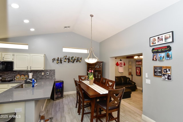 7916 E Naranja Ave, Mesa, AZ 85209 - dining room featuring light wood-type flooring, lofted ceiling, baseboards, and recessed lighting