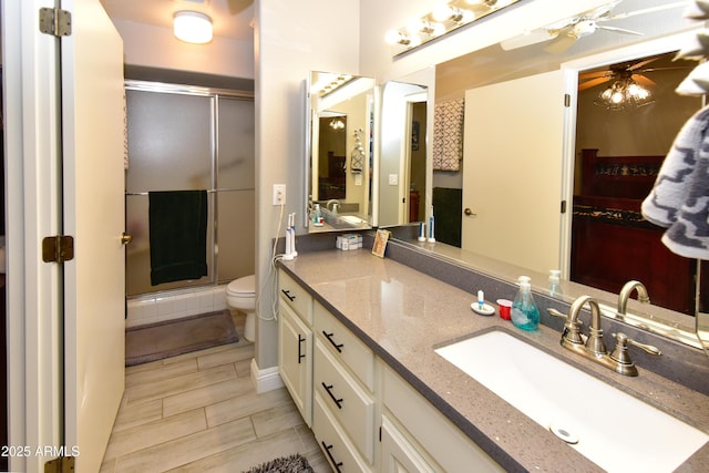 7916 E Naranja Ave, Mesa, AZ 85209 - bathroom with toilet, a ceiling fan, a stall shower, and vanity