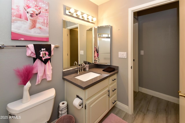 7916 E Naranja Ave, Mesa, AZ 85209 - half bath featuring wood finished floors, toilet, vanity, and baseboards