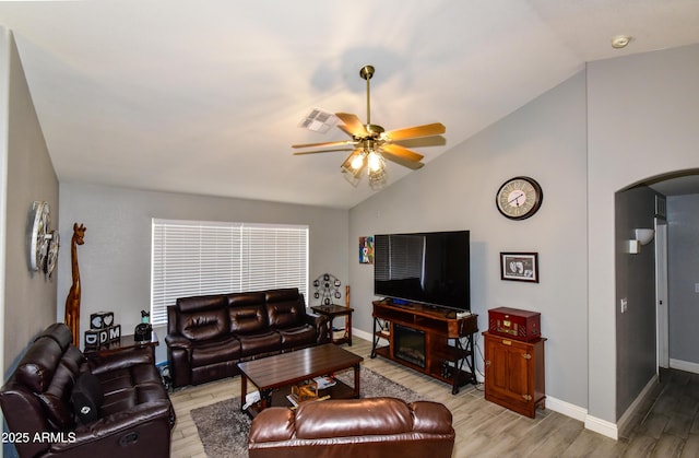 7916 E Naranja Ave, Mesa, AZ 85209 - living area featuring arched walkways, lofted ceiling, a ceiling fan, light wood-style flooring, and baseboards