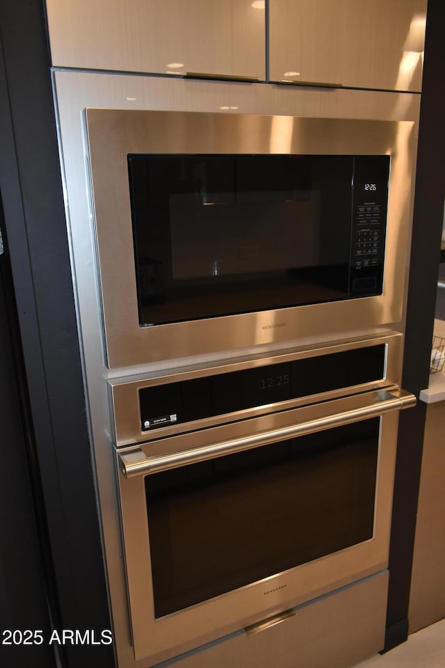 room details featuring stainless steel microwave and light countertops
