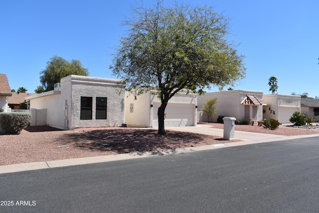 view of front of property with a garage, stucco siding, and concrete driveway