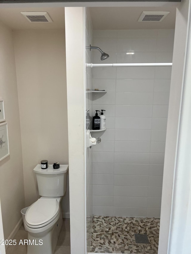 full bathroom with a shower stall, toilet, tile patterned flooring, and visible vents