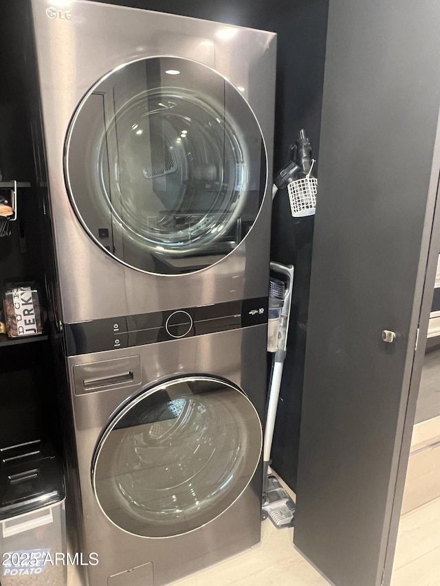 laundry room featuring stacked washer and clothes dryer