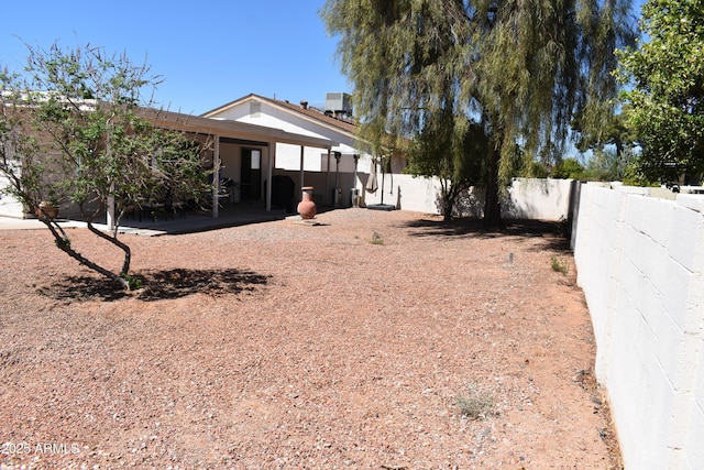 view of yard featuring a fenced backyard and central air condition unit