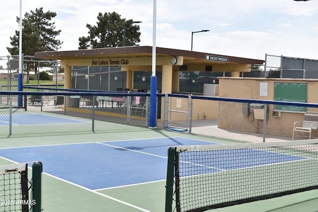 view of tennis court featuring fence