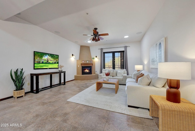 living area with a ceiling fan, a fireplace, baseboards, and recessed lighting