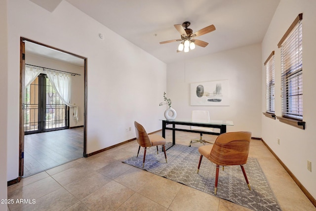 office space featuring a ceiling fan, baseboards, and tile patterned flooring