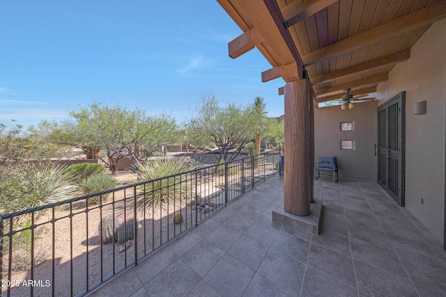 view of patio / terrace with ceiling fan and a balcony