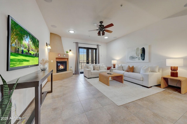 living room with a ceiling fan, a fireplace, light tile patterned floors, and recessed lighting