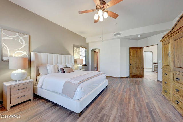 bedroom featuring wood finished floors, baseboards, and ceiling fan